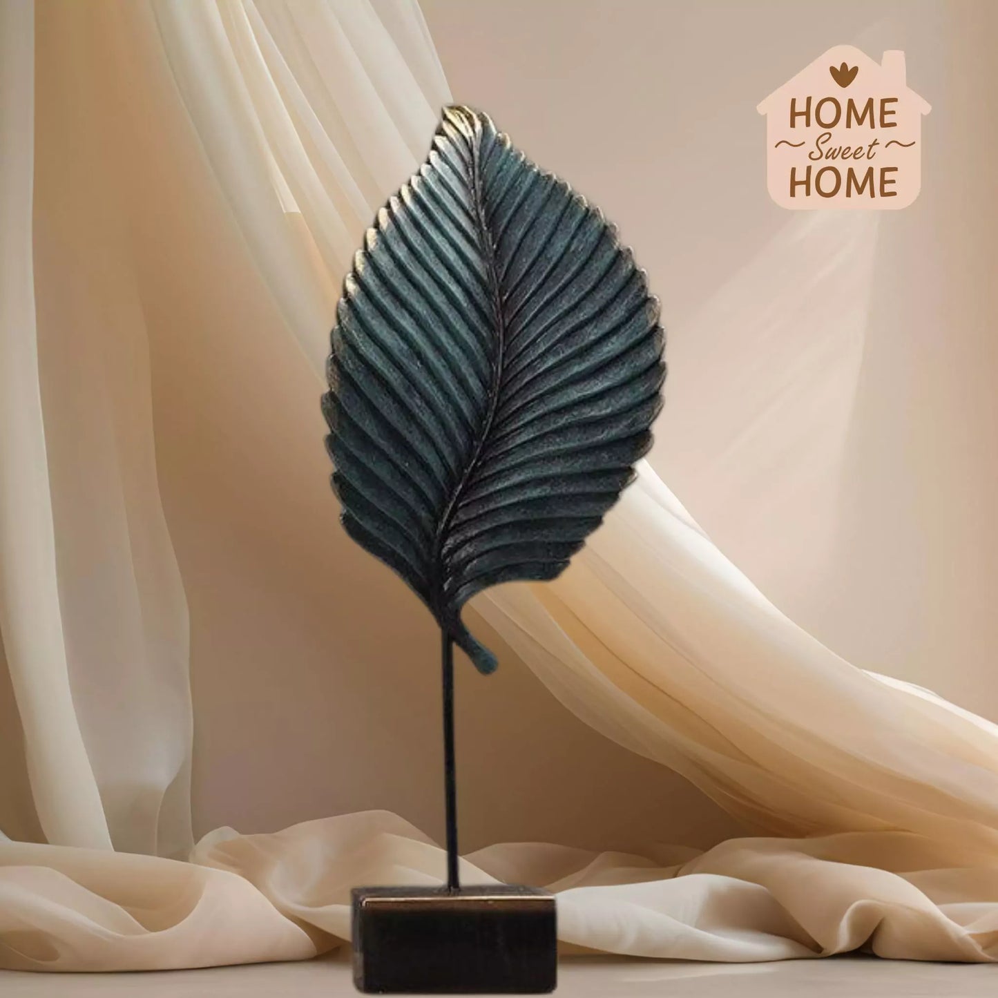 Decorative leaf sculpture on a stand with 'Home Sweet Home' sign in the corner.