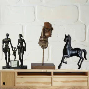 different room decor products like horse statue, family statue etc. placed on a wooden stand.