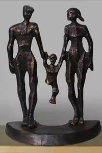 Bronze sculpture of a family with two adults and a child holding hands on a gray background